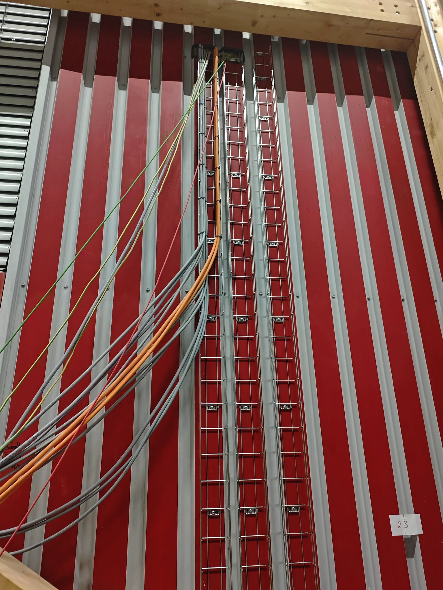 Vertical cable ladders in a building riser