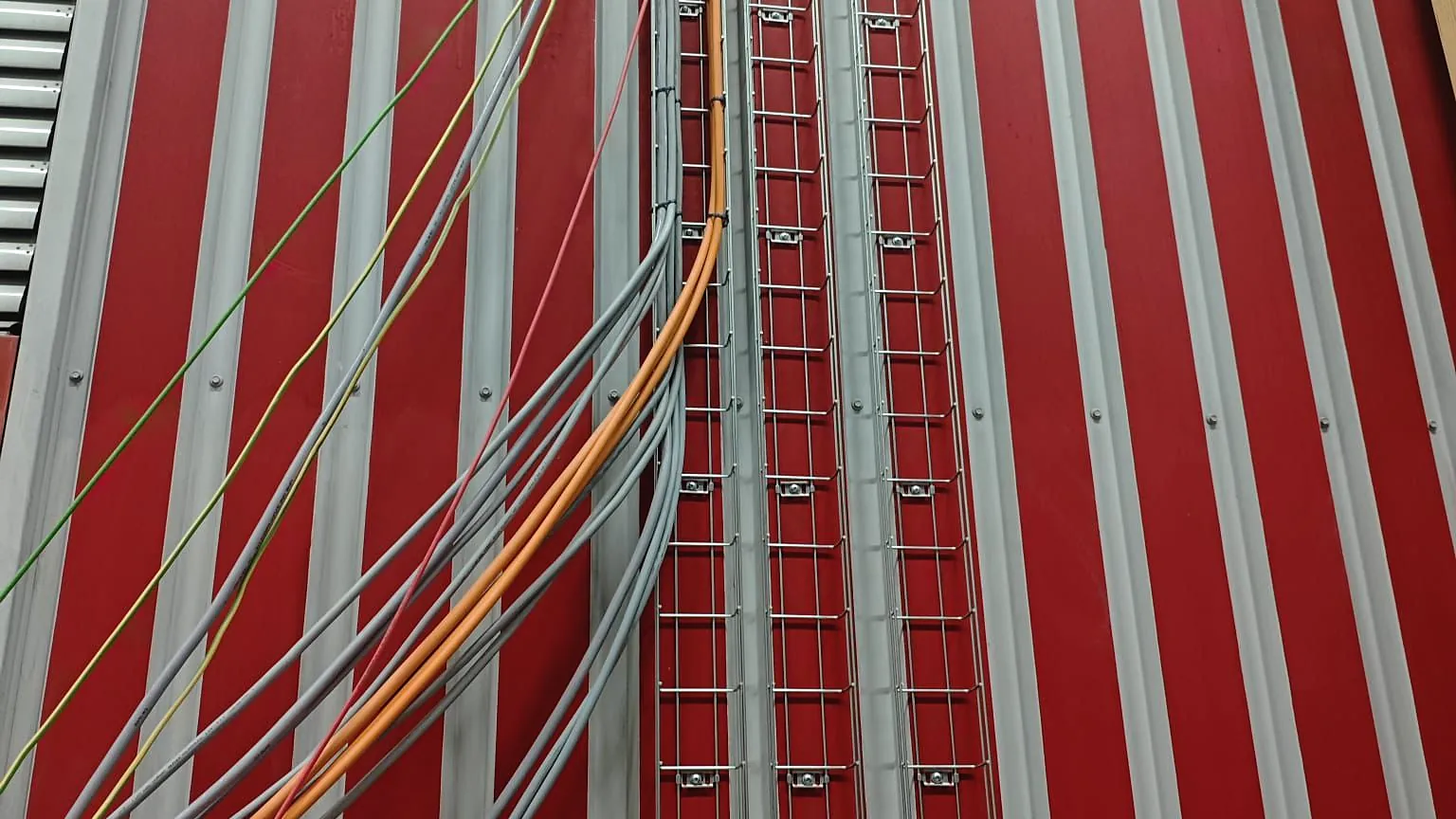 Vertical cable ladders in a building riser